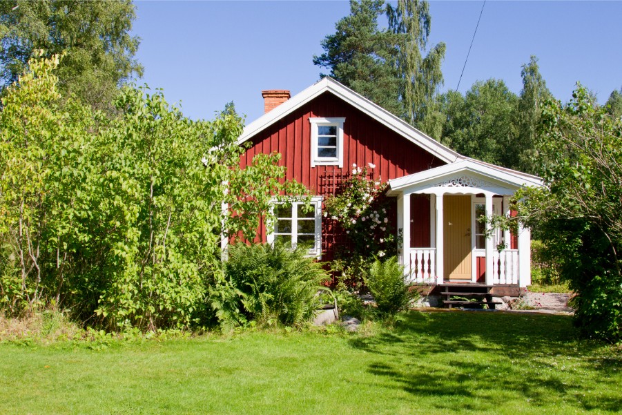red cottage in wooded area