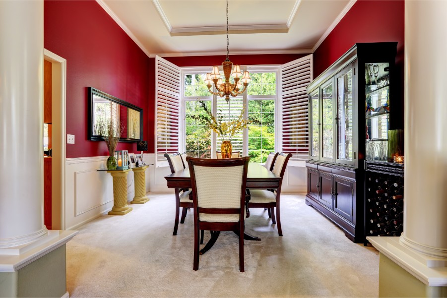 red dining room with white chair rail